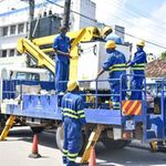 Kenya Power employees repair a transformer.