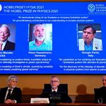 A screen displaying the winners of the 2021 Nobel Prize in Physics