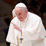 Pope Francis waves to pilgimsat Paul-VI hall in The Vatican.